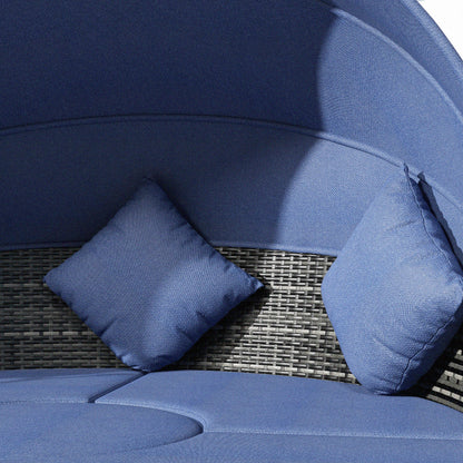 Navy backrest with two blue accent pillows on woven rattan seat