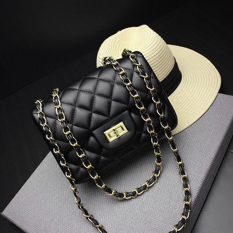 Black quilted mini one-shoulder messenger bag with gold chain strap and front clasp