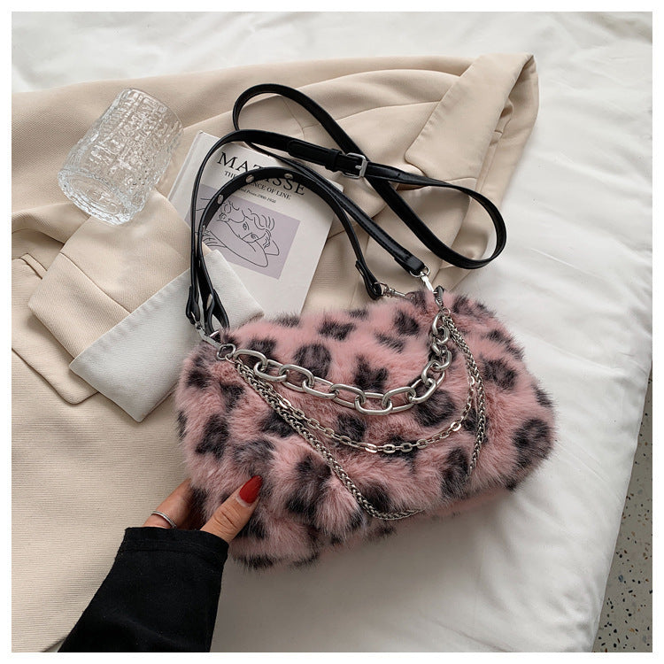 Pink plush leopard print shoulder bag with silver chain hardware and black leather straps