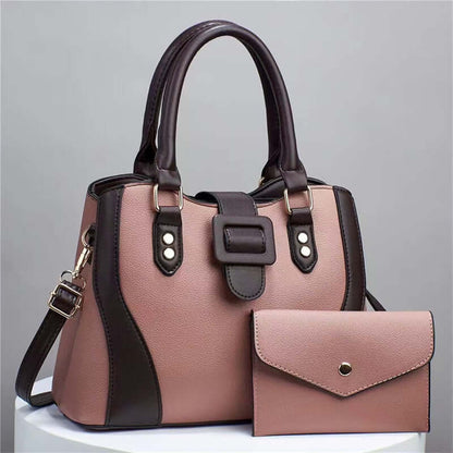 Pink faux-leather tote bag with black trim and matching envelope clutch pouch