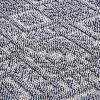 Flatwoven rug texture with diamond and zigzag motifs in gray and white