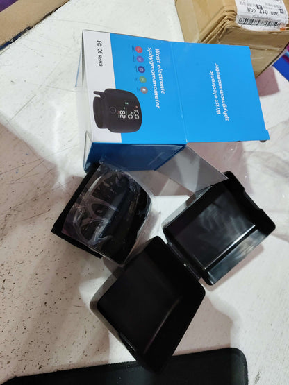 Blue retail box with black wrist blood pressure monitor and wrist strap