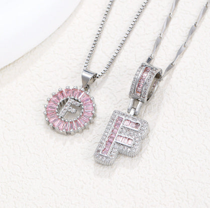 Silver-tone pendant necklace set with pink crystal flower halo pendant and letter charm
