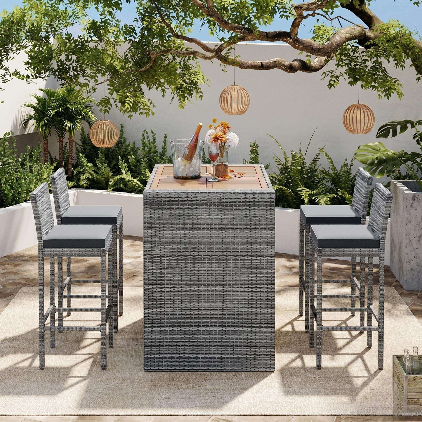 Outdoor patio wicker bar set with gray wicker table, four stools, and acacia top