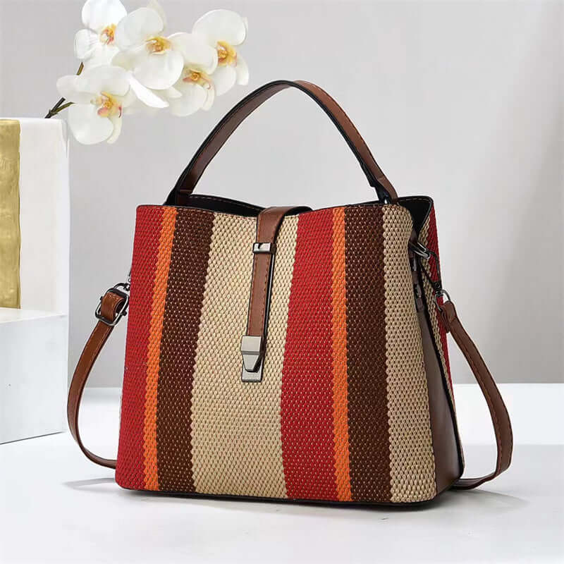 Large crossbody handbag in cream and rust vertical stripes with brown top handles
