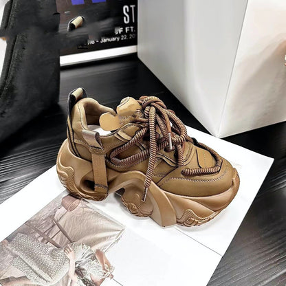 A pair of women's sneakers with thick soles and lace-up closure, displayed in a store setting, with one sneaker in brown color and the other in black color.