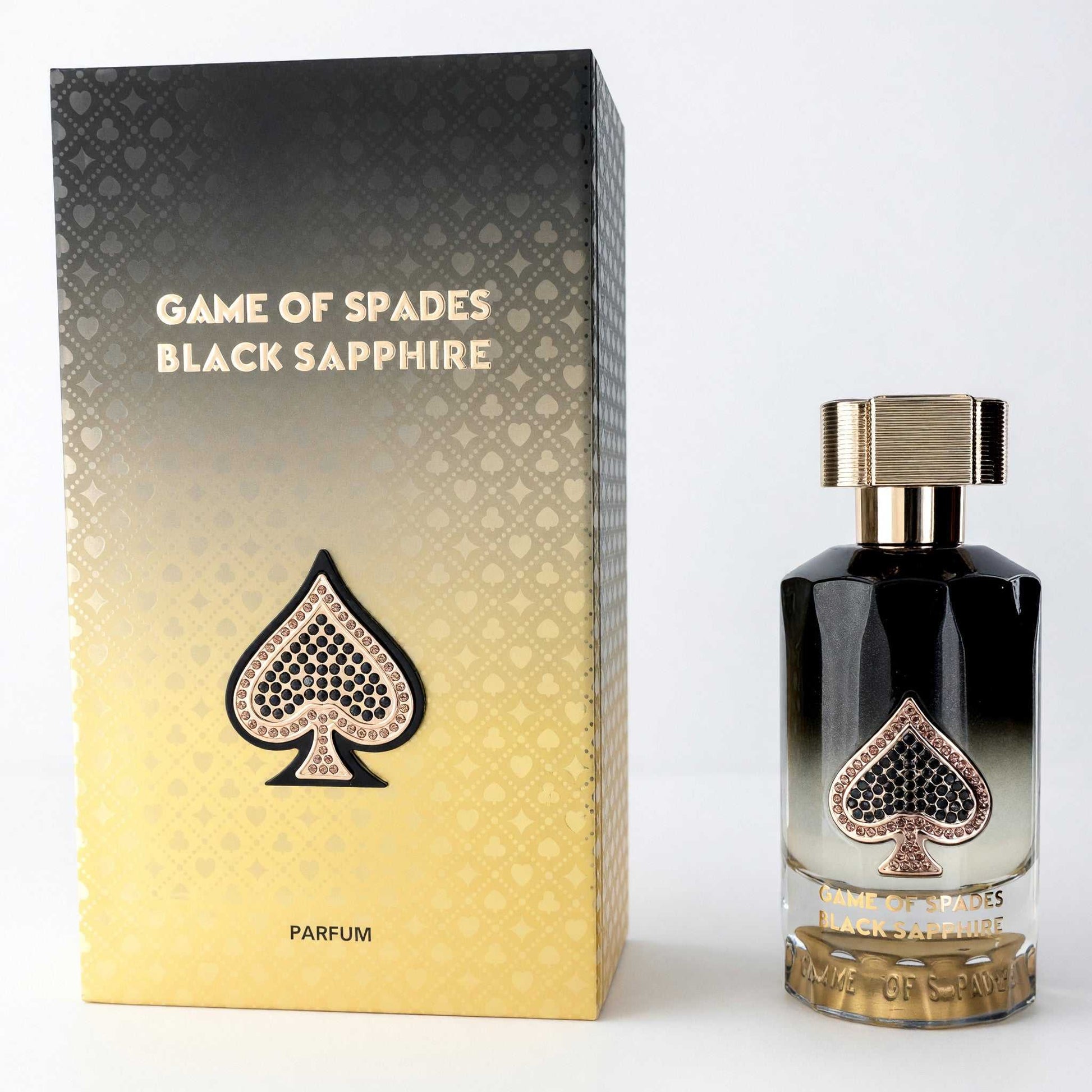 Black glass parfum bottle with gold cap and spade label, with boxed packaging