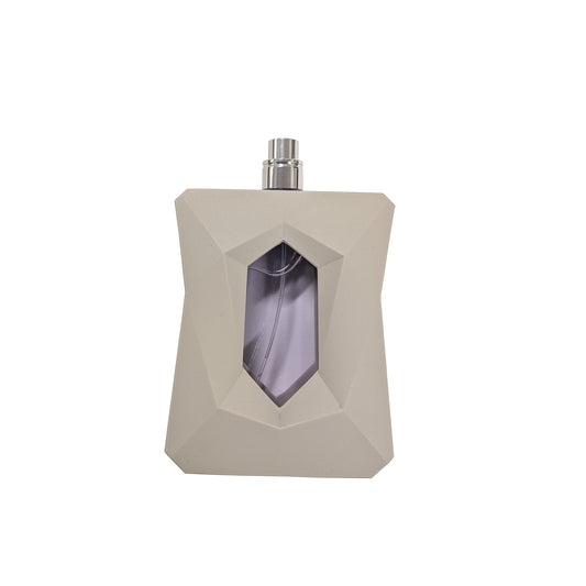 Beige faceted eau de parfum tester bottle with silver spray cap and purple window