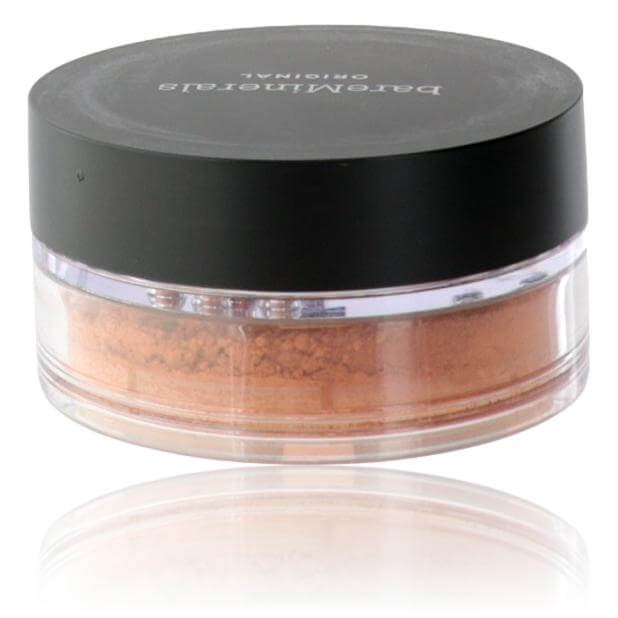 Loose powder foundation in round clear jar, golden-brown loose powder