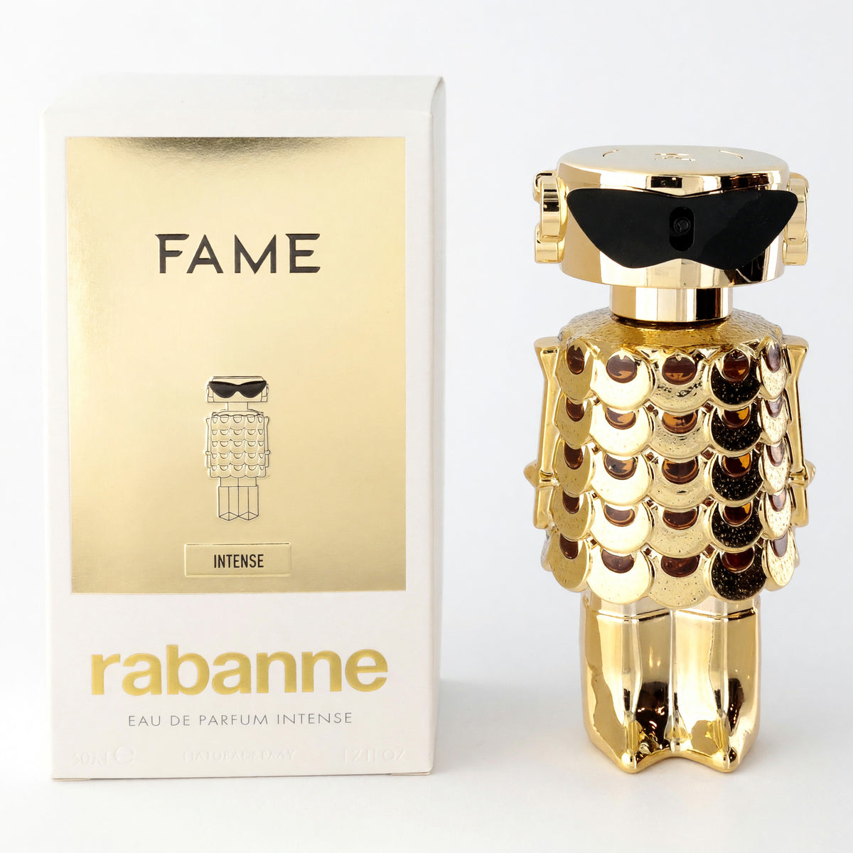 Fame Intense perfume spray bottle and box, with a sculpted gold finish and black cap