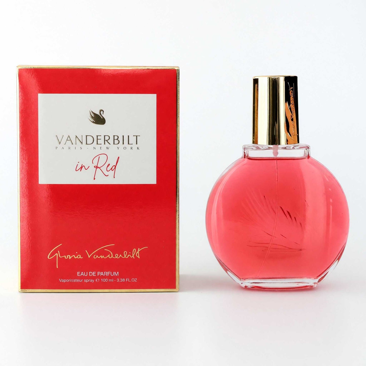 Red glass perfume bottle with gold cap, with matching Gloria Vanderbilt box.