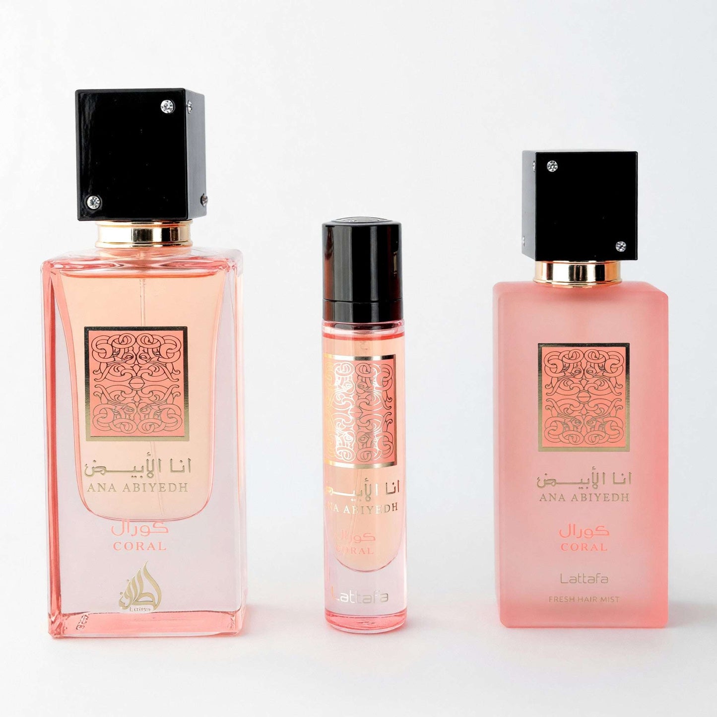 Coral pink 3-piece perfume gift set with three bottles and black caps