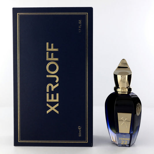 Unisex EDP spray bottle with dark blue glass and gold cap, with matching gift box