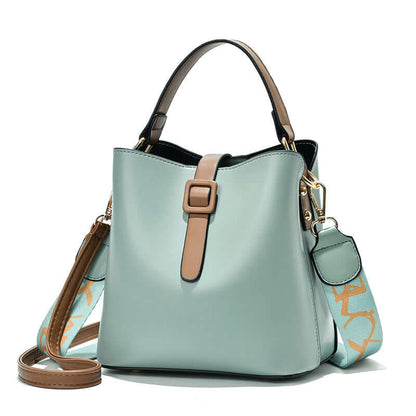 Mint PU leather bucket bag with zip top, top handles, and small side charm pocket
