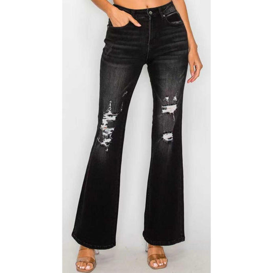 A model wearing black low-waist flare jeans with a slim fit through the thigh and a wide bell-bottom opening at the hem.