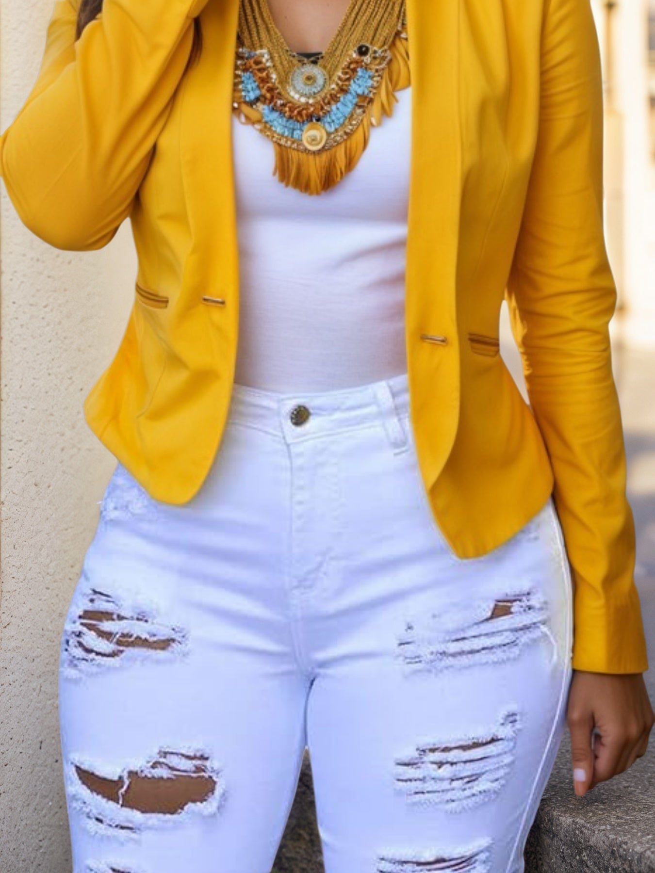 White distressed denim shorts with wide leg rips and frayed edges
