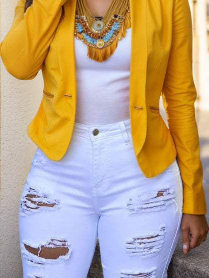 White distressed denim shorts with wide leg rips and frayed edges