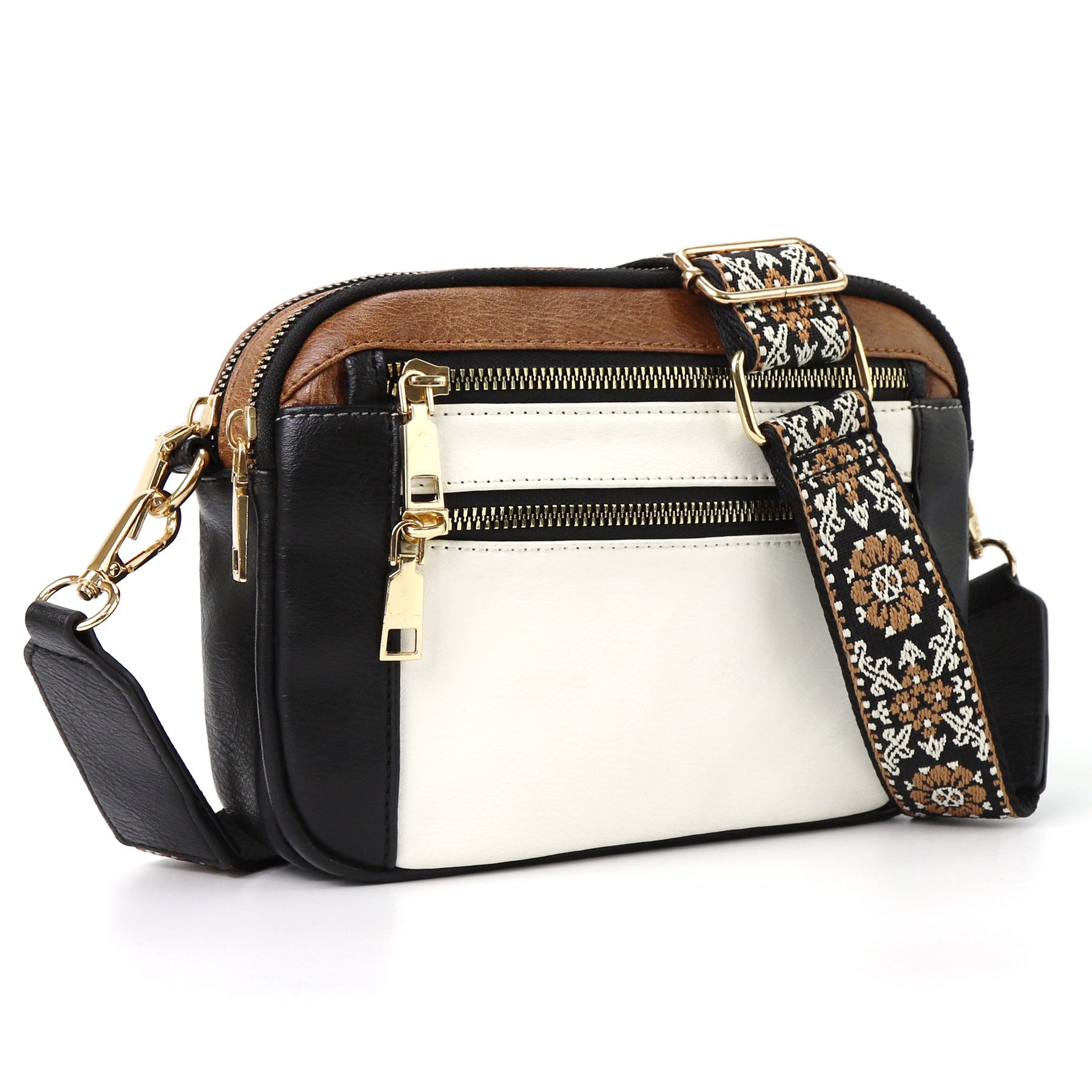 Black and white triple-zip crossbody bag with floral patterned strap and gold hardware