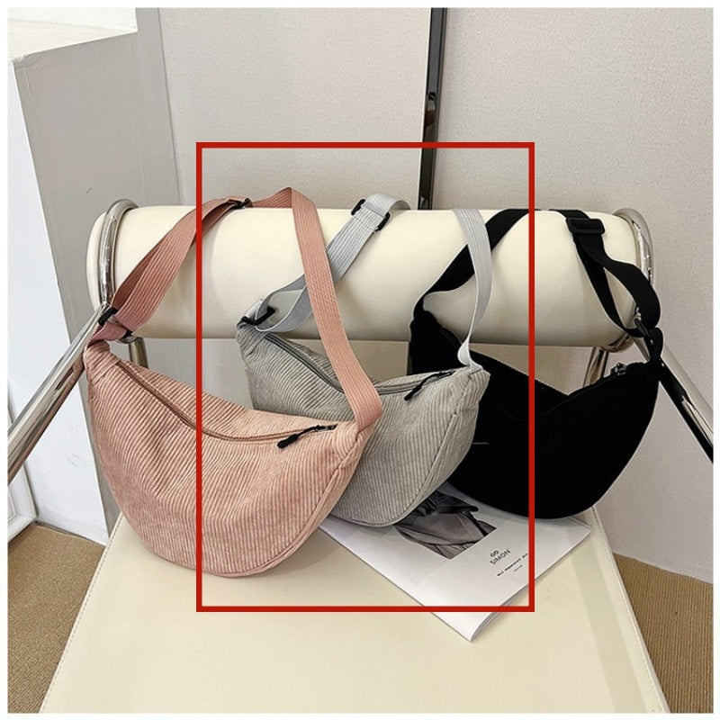 Large dumpling crossbody bags in blush and black with adjustable shoulder straps