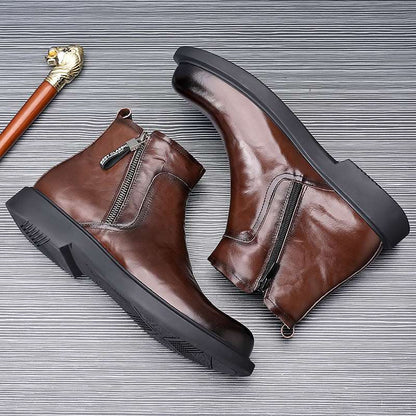 Brown leather boots with black soles on a textured gray background