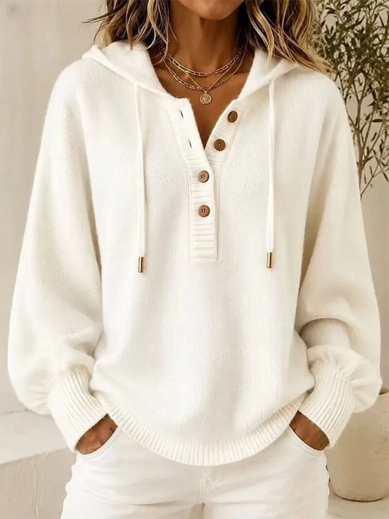 White hooded knit sweater with button placket, drawstring cords, and ribbed cuffs