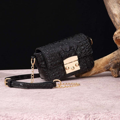 Black croc-textured crossbody bag with flap and gold-tone lock hardware