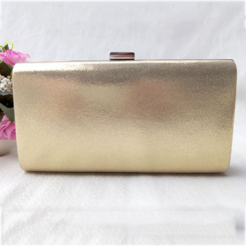 Gold glitter evening clutch bag with metal bar clasp