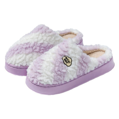 Pair of purple and white slippers on a white background
