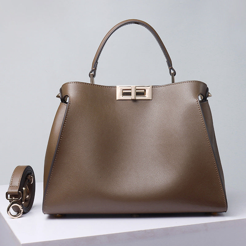 Medium brown crossbody handbag with top handles, gold-tone lock clasp and side strap