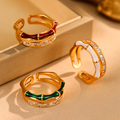 Gold-tone open ring with red and green enamel, each with zircon stones