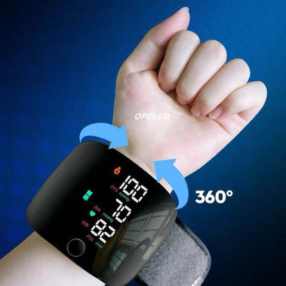 Black wrist blood pressure monitor on hand wrist with 360° rotating display