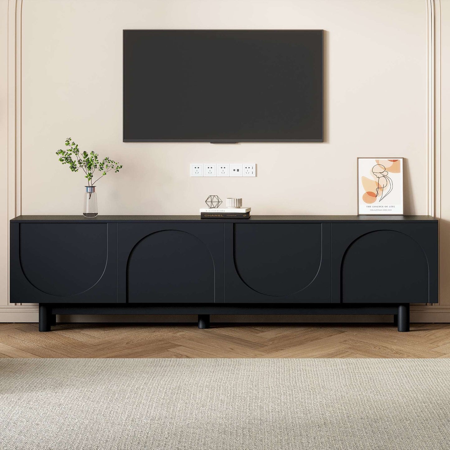 Black TV stand with arched cabinet doors and low long console profile