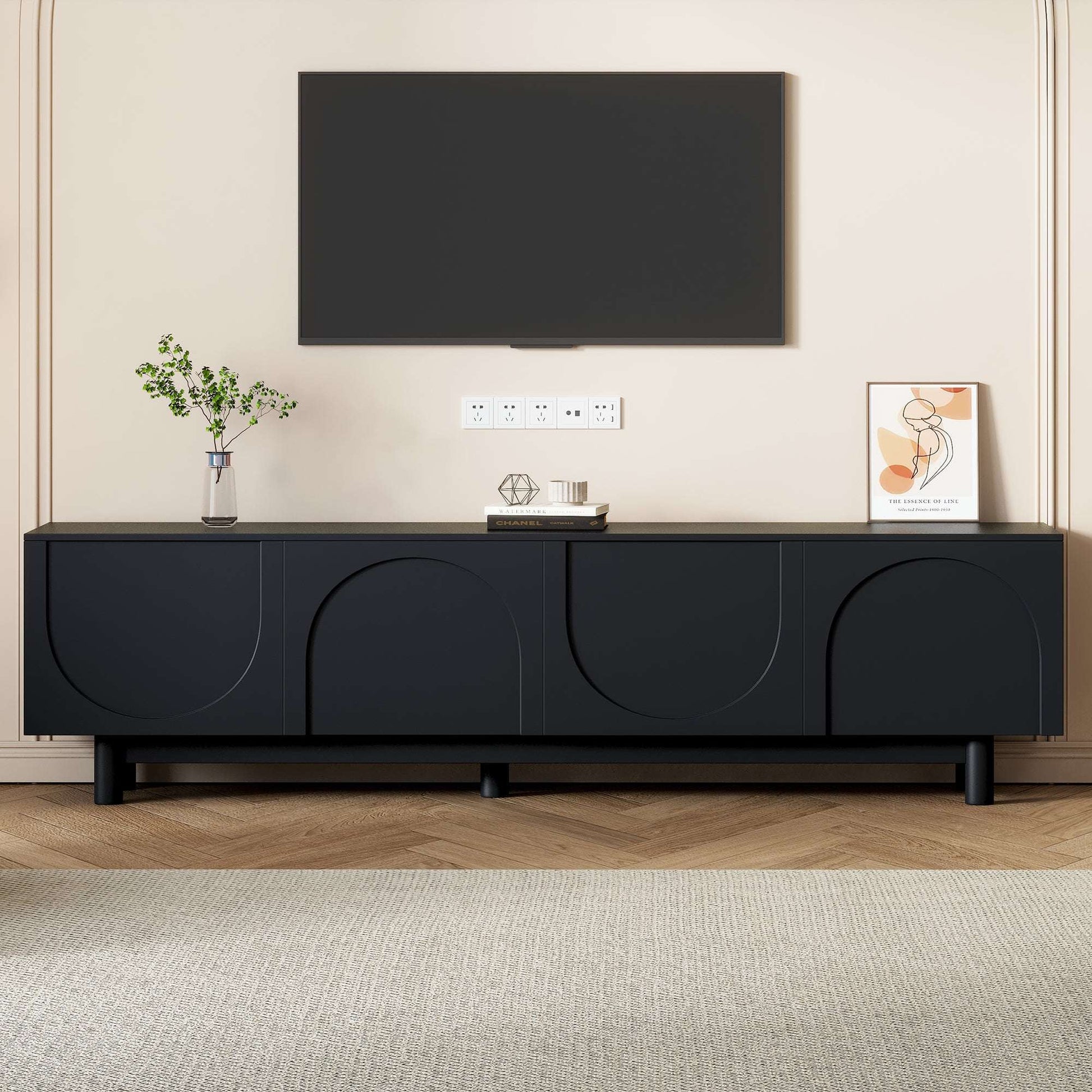 Black TV stand with arched cabinet doors and low long console profile