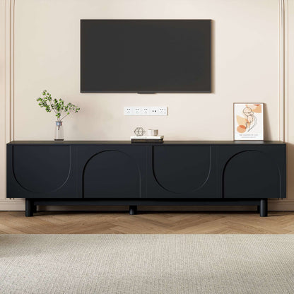 Black TV stand with arched cabinet doors and low long console profile