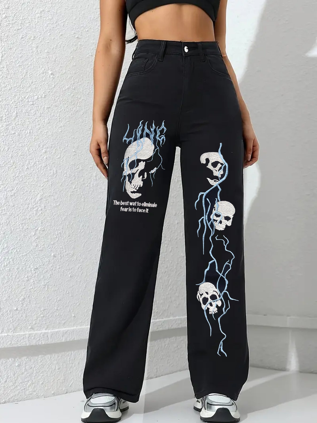Black women’s jeans with skull and flame embroidery on front wide-leg panels