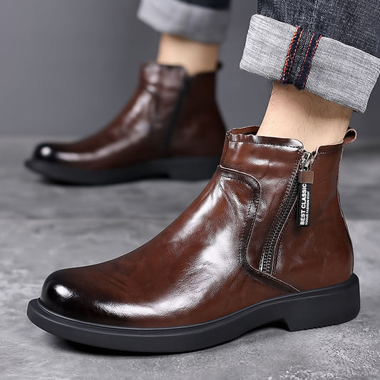 Brown leather ankle boots with a zipper on a gray surface