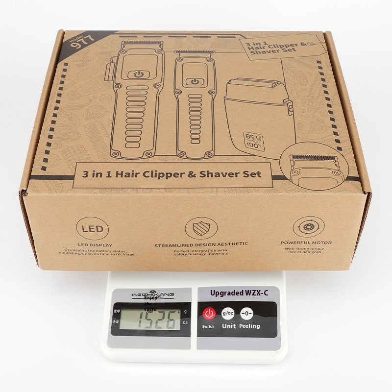 Cardboard box packaging for a 3-in-1 hair clipper and shaver set on a white background.