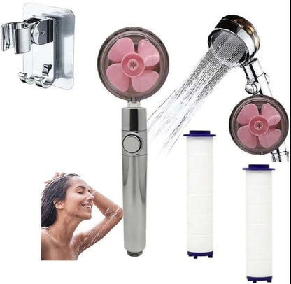 Handheld shower head set with chrome handle, pink rotor face, and two filter cartridges