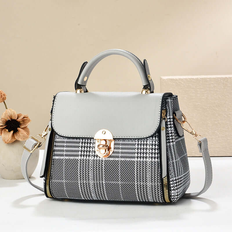 White and gray houndstooth envelope shoulder tote with gold clasp and side straps