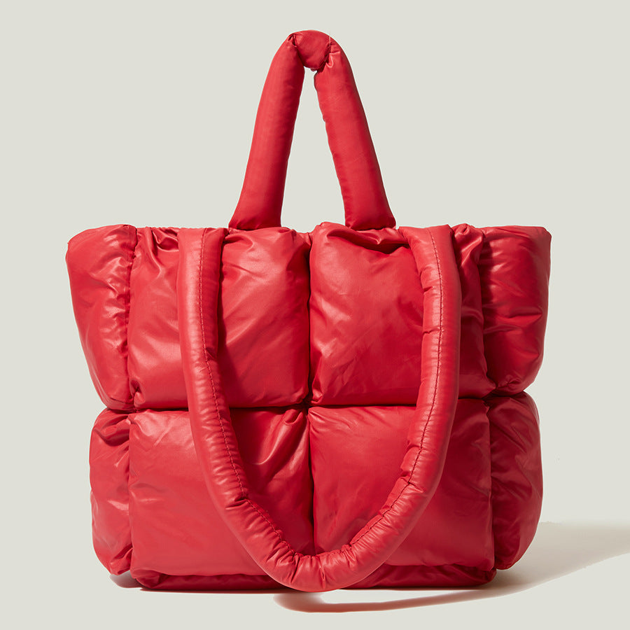 Red puffy one-shoulder handbag with quilted panels and gathered top handles