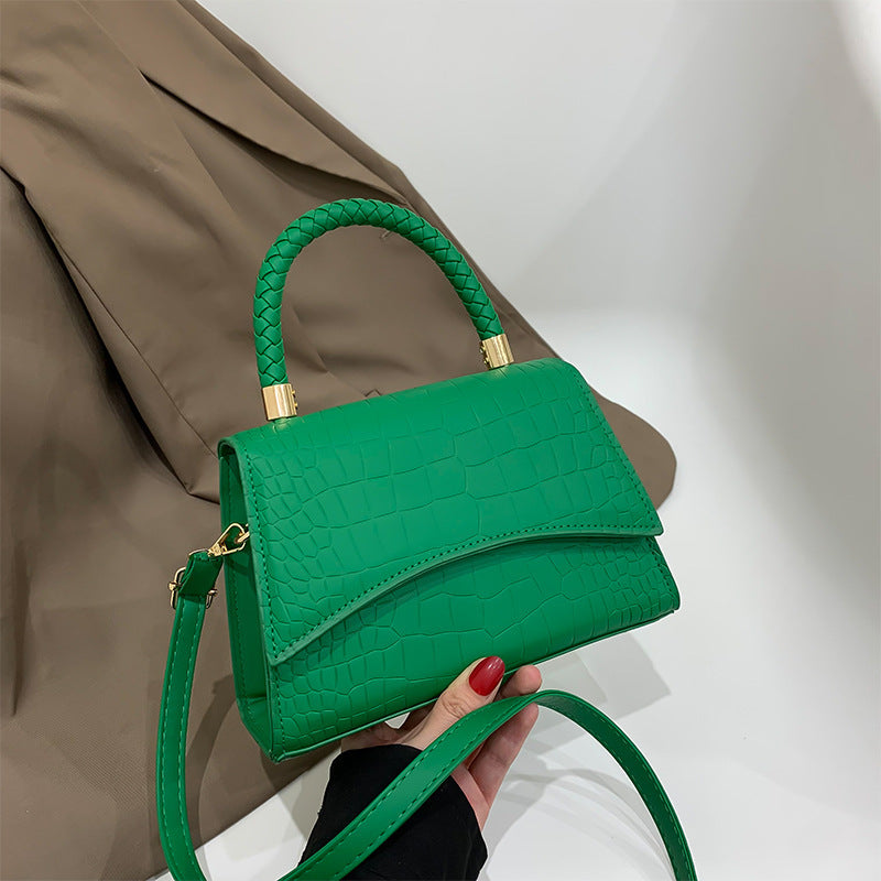 Green croc-texture shoulder bag with top handle, flap front, and gold hardware