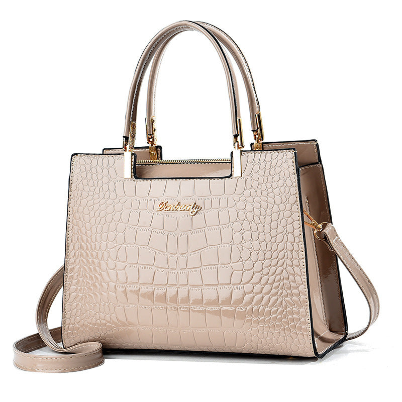 Cream croc-texture tote with top handles and side shoulder strap, structured rectangular bag