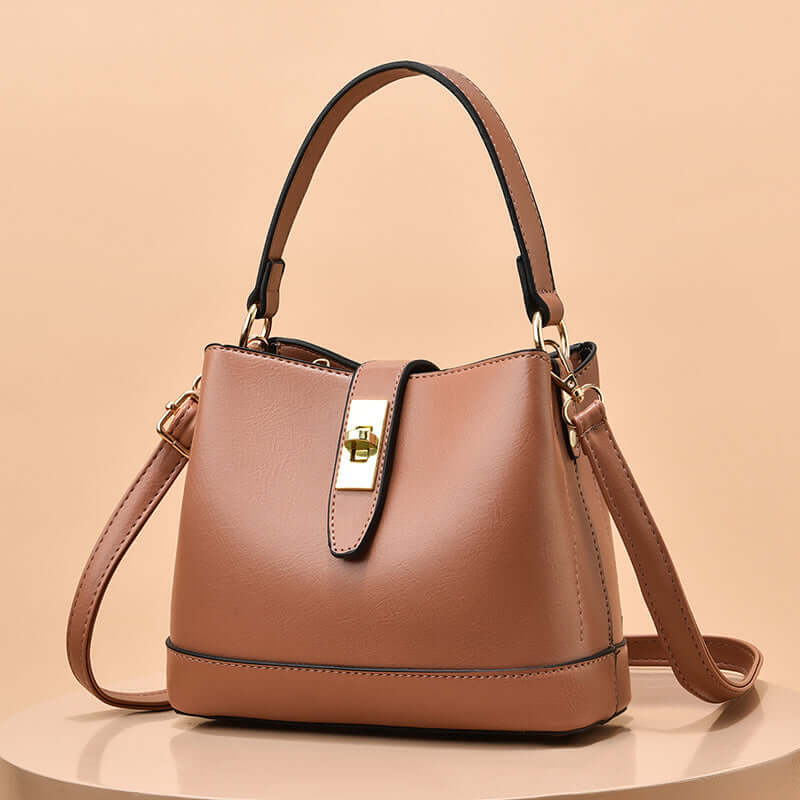 Lightweight handbag tote with top handle, shoulder strap, and front buckle pocket