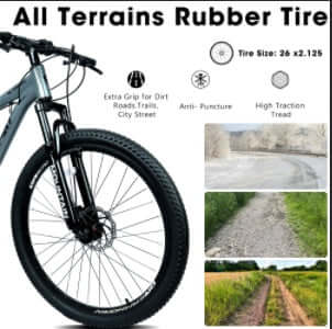 Front wheel and knobby all-terrain tire on grey mountain bike with black fork