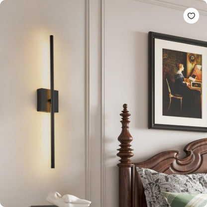 Black LED wall sconce with vertical bar and rectangular mount, softly lit
