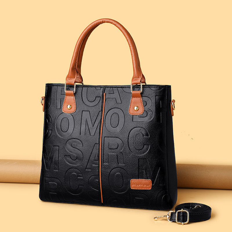 Large capacity printed leather shoulder bag, black with tan handles and small crossbody strap