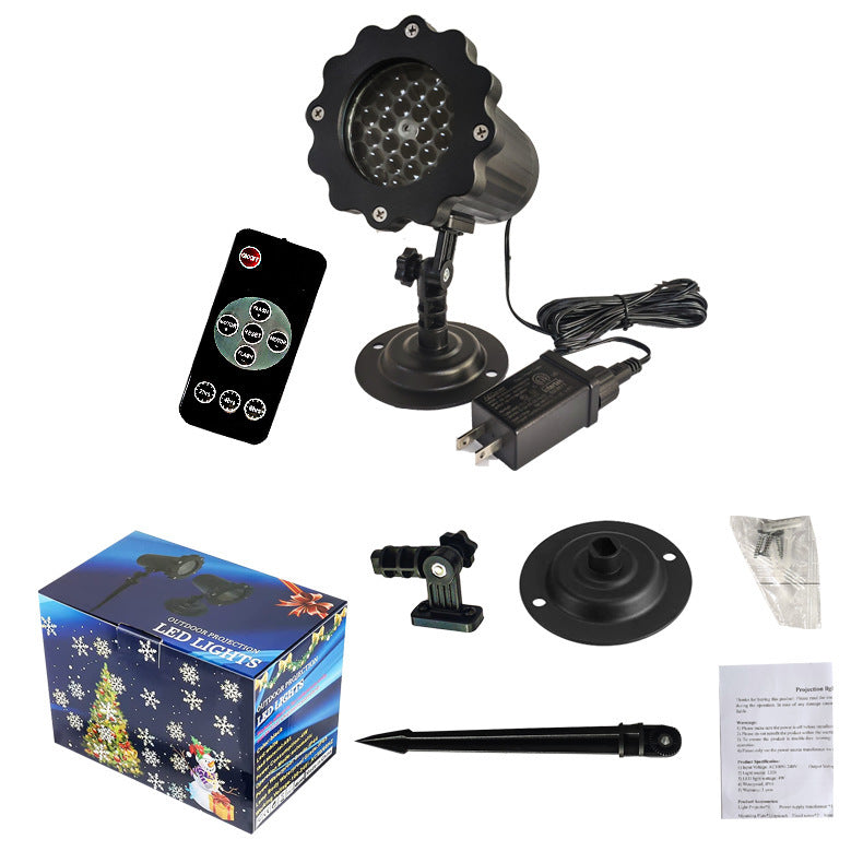 Christmas light projector with remote control, power adapter, and packaging on a white background