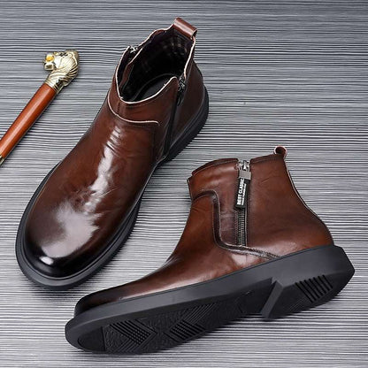 Pair of brown leather boots on a textured gray background