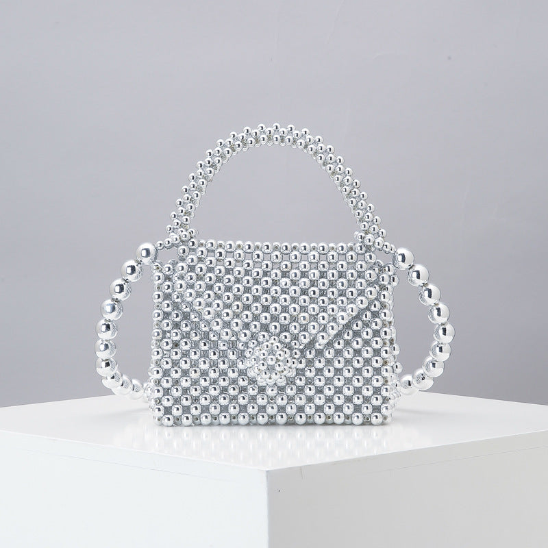 Silver beaded mini tote bag with arched top handle and woven mesh bead body