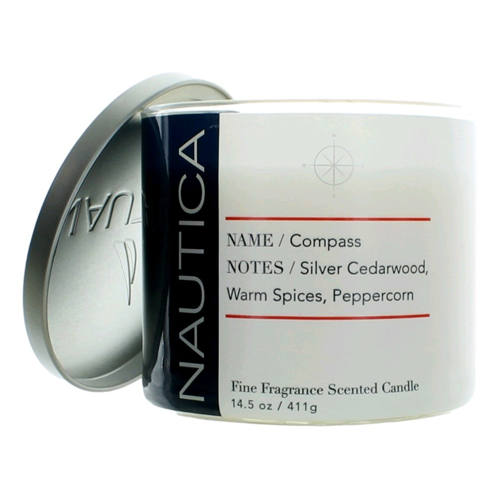 Compass scented candle in clear glass jar with white label and silver lid